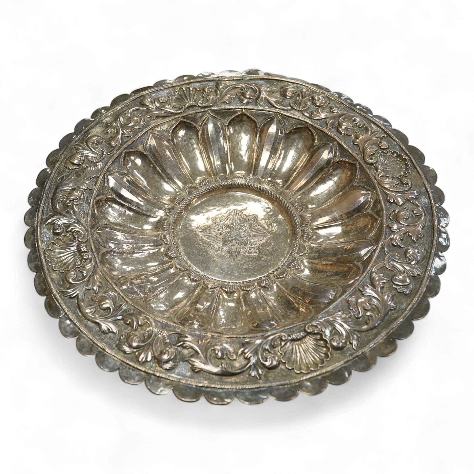 A 19th Century Indian white metal repousse dish, with cusped border, diameter 26.1cm, 14.1oz.